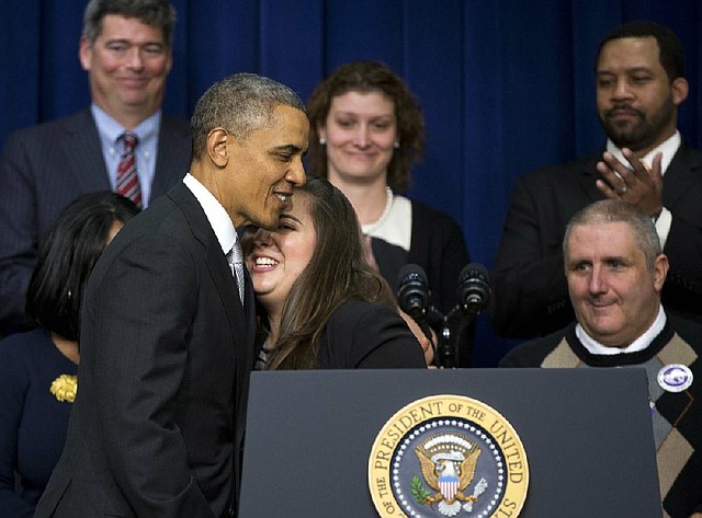 President Barack Obama hugs Monica Weeks at an event Tuesday in the Eisenhower Executive Office Building on the White House grounds. Weeks said the new health-care law allowed her to stay on her parents’ insurance and be treated for Crohn’s disease. 