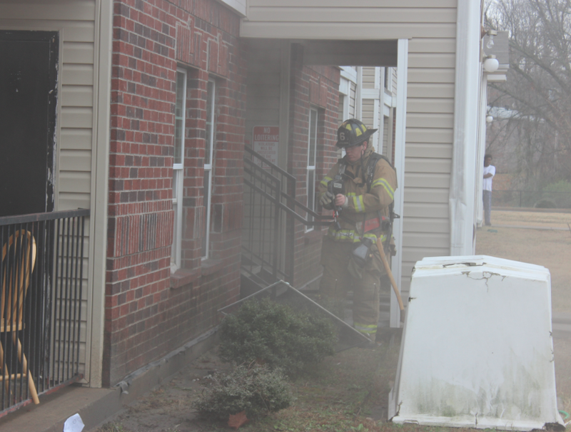 A firefighter works amid light smoke at the scene of a fire at the Stonewood Apartments, 3600 Springer Blvd. in Little Rock, on Wednesday, Dec. 4, 2013.