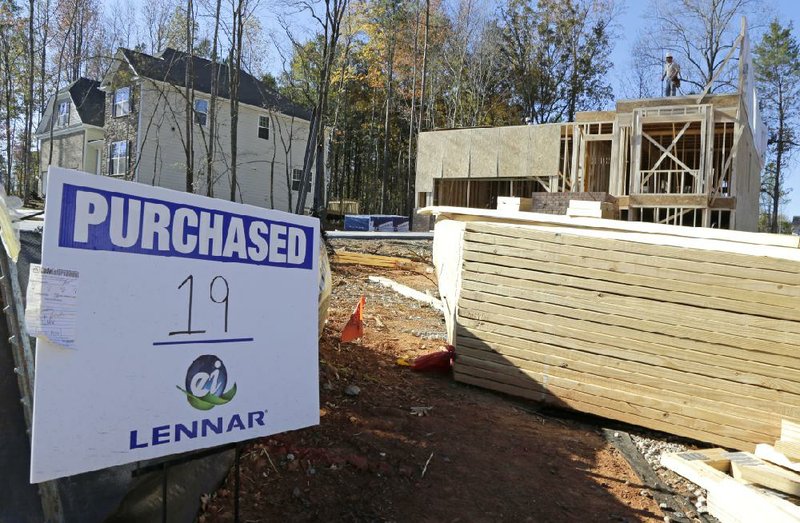 Workers frame a house being built in Matthews, N.C., in November. Sales of new homes grew in October to a seasonally adjusted annual rate of 444,000, the Commerce Department said Wednesday. 