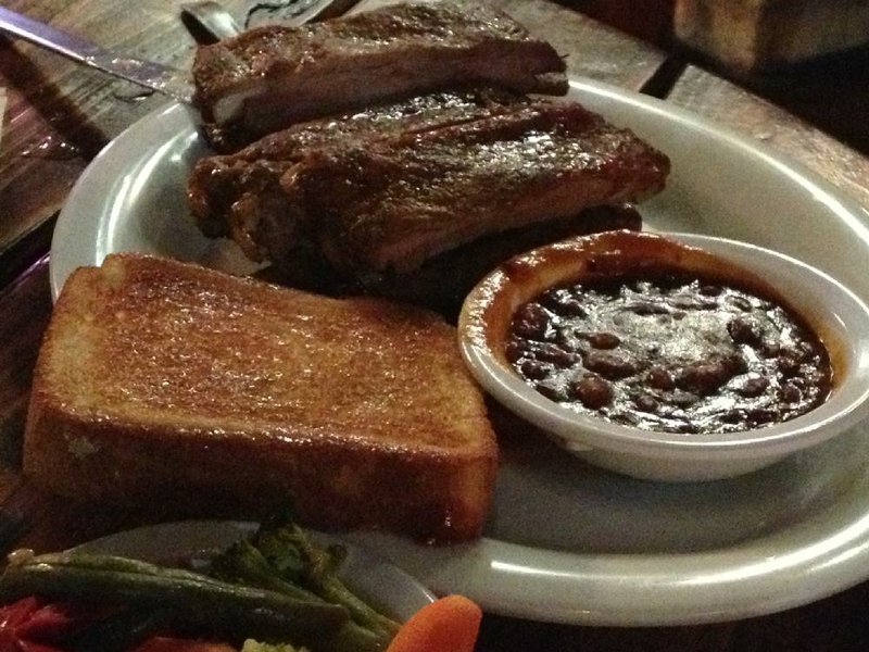 The Godfather (ribs) comes with baked beans, toast and vegetables at the Blind Pig Bar and Grill in west Little Rock. 