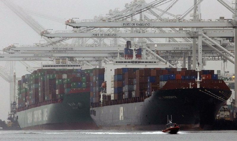 Container ships wait to be unloaded in a thick fog at a dock in Oakland, Calif., in October. The U.S. trade gap decreased in October to $40.6 billion, the Commerce Department said. 