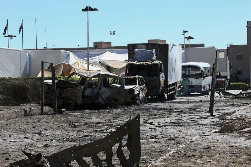 This photo provided by Yemen's Defense Ministry shows damaged vehicles after an explosion at the Defense Ministry complex in Sanaa, Yemen, Thursday, Dec. 5, 2013. A suicide bomber detonated his explosives-laden car Thursday at Yemen's Defense Ministry, killing more than a dozen soldiers and wounding at least 40 in an attack underlining the persistent threat to the stability and security of the impoverished Arab nation, military and hospital officials said.