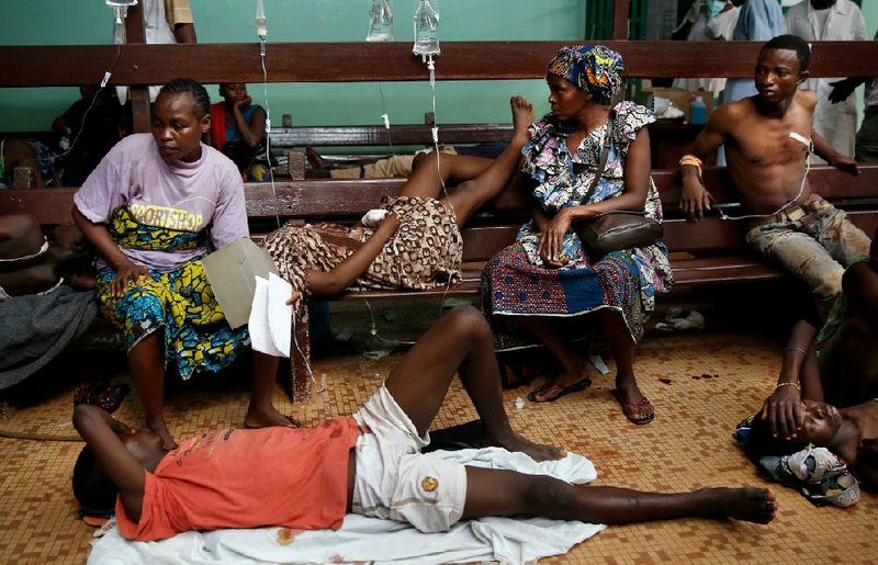 Civilians wait for treatment Thursday at the hospital in Bangui, Central African Republic, after a day-long gunbattle between soldiers of the Muslim rulers and Christian militias. 
