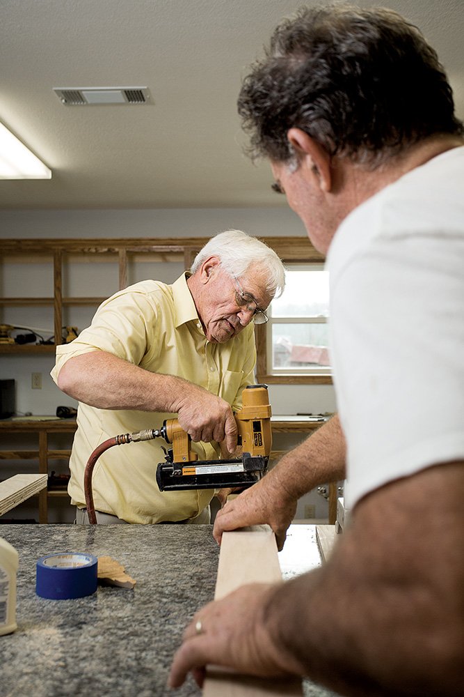 Ester Bass, left, pastor of Botkinburg Foursquare Church, works with church member Ron Watts to finish the kitchen in the facility. The former church was destroyed in an April 10 tornado. Church services will be held in the Fellowship Hall today for the first time in the new building, 7054 U.S. 65 N., weather permitting, Bass said. Sunday School is at 10 a.m., and church is at 11. For more information, call Bass at (501) 253-3532.