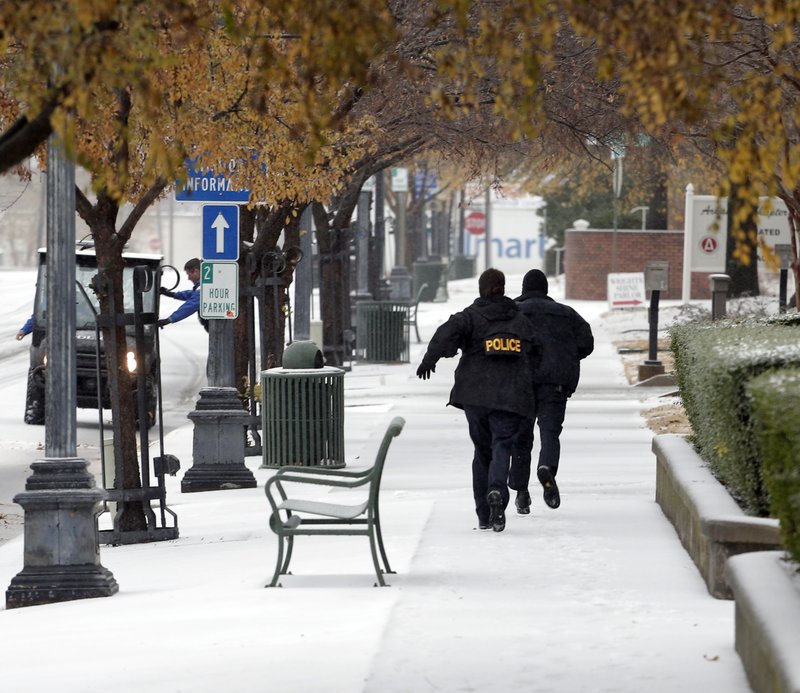 Police search for a suspect in a bank robbery Friday morning in downtown Little Rock.