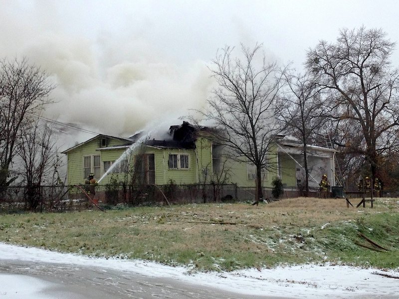 Firefighters battle a blaze at 2109 S. Ringo St. in Little Rock on Friday, Dec. 6.