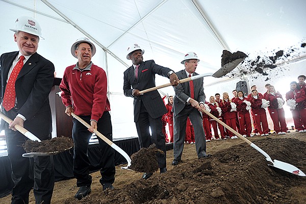 University of Arkansas chancellor G. David Gearhart, women's head basketball coach Tom Collen, men's head basketball coach Mike Anderson, and athletic director Jeff Long throw dirt during the official groundbreaking for the new Razorback Basketball Performance Center Saturday afternoon in Fayetteville.