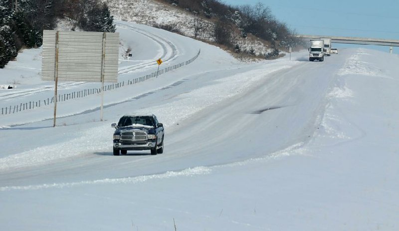 Traffic moves slowly across the ice covered south bound lanes of interstate 540 south of Greenland after a December winter storm.