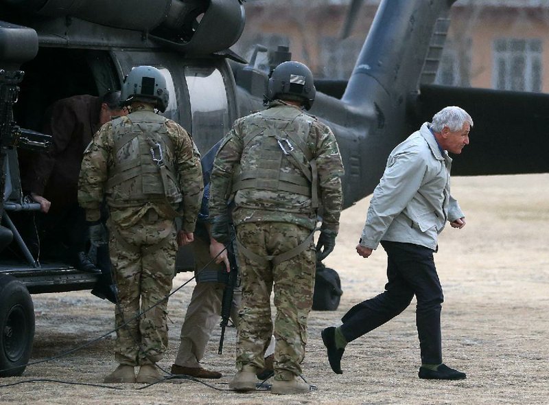 Defense Secretary Chuck Hagel (right) arrives Saturday in Kabul on an unannounced visit to Afghanistan. The visit will not include a meeting with Afghan President Hamid Karzai, Hagel insisted. 