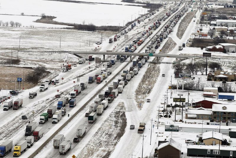 Traffic grinds to a standstill Saturday on Interstate 35 in Sanger, Texas, near Denton. Sections of the interstate north of Dallas were closed for hours at a time because of wrecks and stalled vehicles. 