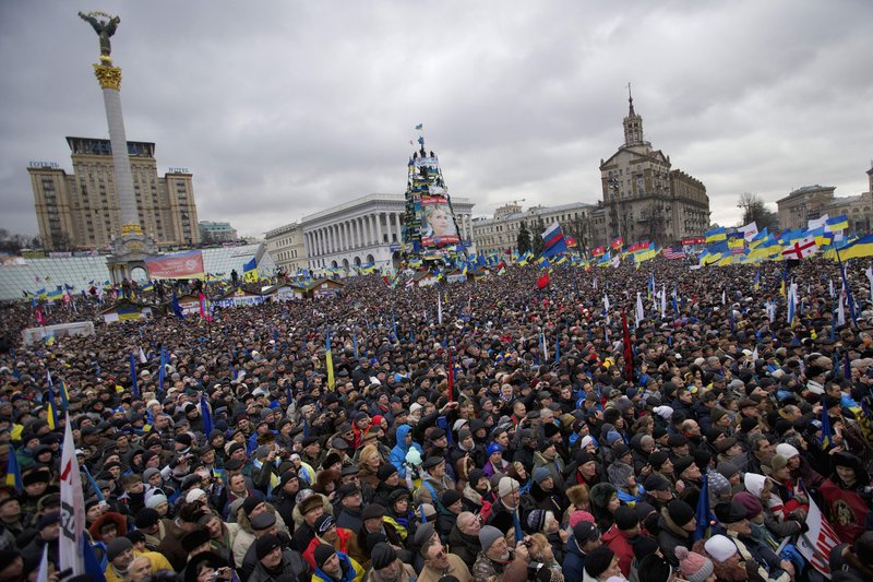 Pro-European Union activists gather during a rally in the Independence Square in Kiev, Ukraine, Sunday, Dec. 8, 2013. Over 200,000 angry Ukrainians occupied a central Kiev square on Sunday, to denounce President Viktor Yanukovych’s decision to turn away from Europe and align this ex-Soviet republic with Russia, as massive protests continued for a third week. (AP Photo/Alexander Zemlianichenko)