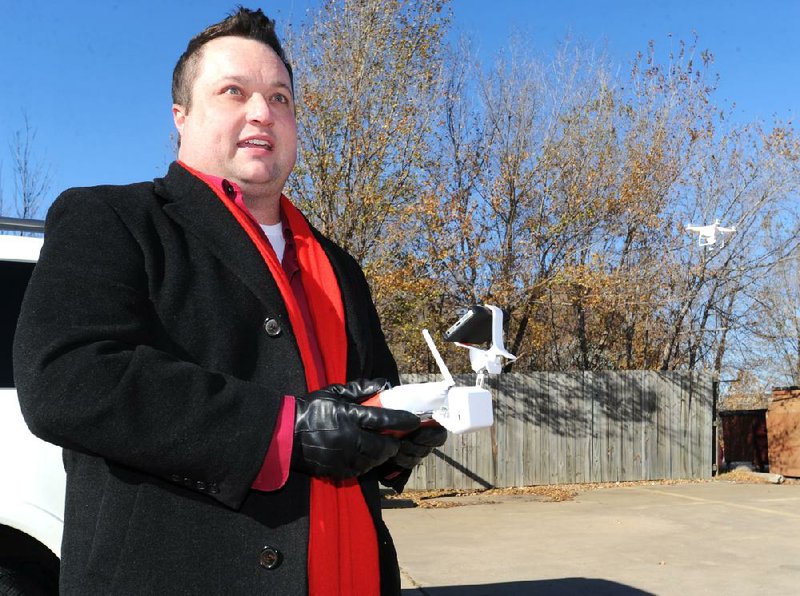 NWA Media/ANDY SHUPE - Tim Stein, executive broker with Bassett Mix & Associates, Inc., pilots a remote-controlled drone that he uses to record video and still photographs of properties Wednesday, Nov. 27, 2013, at the real estate company's office in Fayetteville.