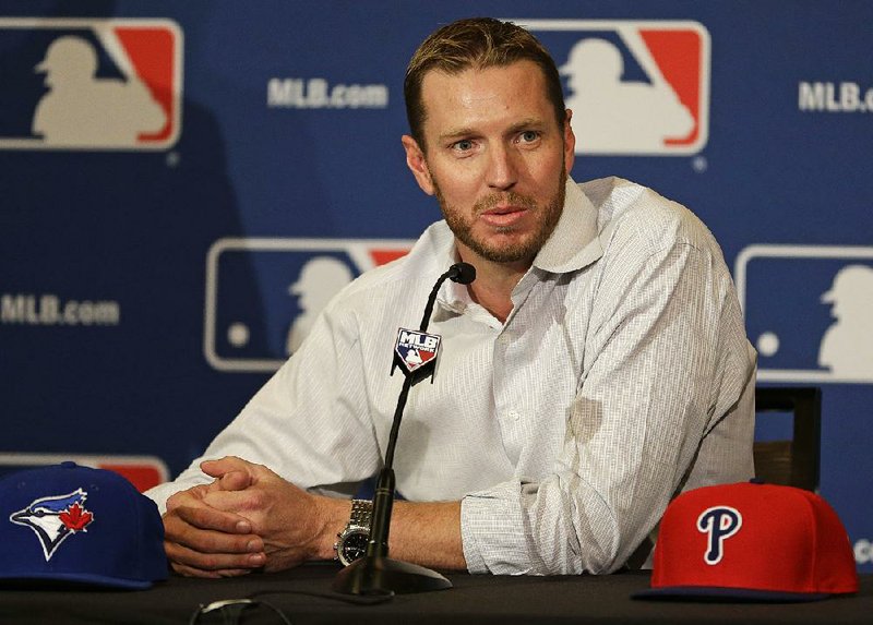 Two-time Cy Young Award winner Roy Halladay answers questions after announcing his retirement after 16 seasons in the major leagues with Toronto and Philadelphia at the MLB winter meetings in Lake Buena Vista, Fla., Monday, Dec. 9, 2013.(AP Photo/John Raoux)