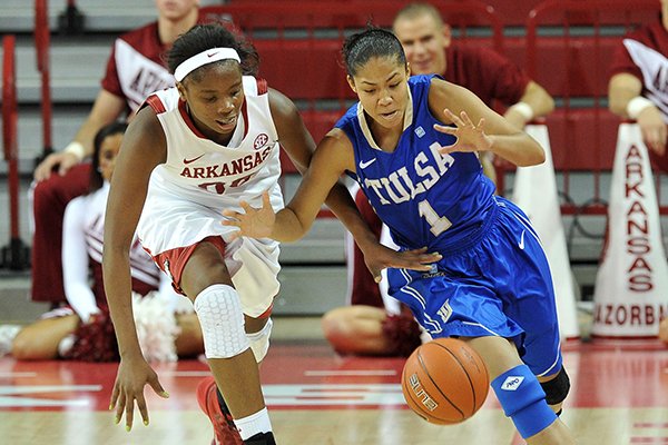 Arkansas forward Jessica Jackson and Tulsa guard Jasmine Vasquez go after a loose ball during the first half of Tuesday night's game at Bud Walton Arena in Fayetteville.