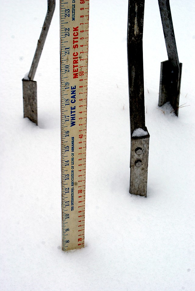 Photo by Dodie Evans The record breaking early December snow that blanketed the area last Thursday and Friday, measured 7 1/2 inches as shown on this White Cane yard stick standing near the legs o...