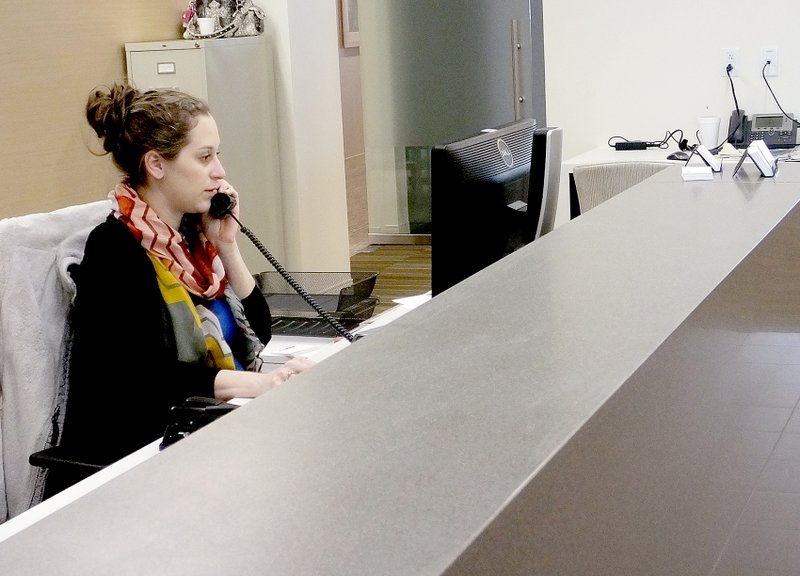 Cassi Lapp/The Weekly Vista Medical support representative Ashleigh Severson reschedules an appointment at the new Mercy clinic facility open in Bella Vista. Winter weather caused a few delays in ...