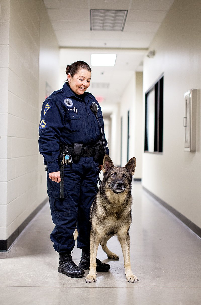 Roby, a 10-year-old German shepherd and officer with the Jacksonville Police Department’s K-9 Unit, stands with his handler, Regina Boyd. The department is looking to retire Roby by mid-February.