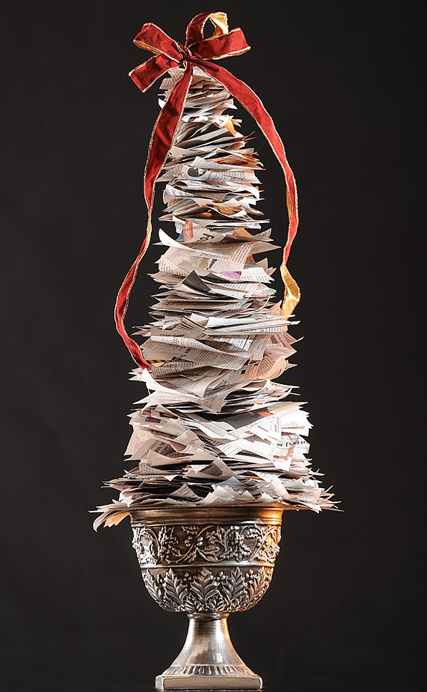 STAFF PHOTO ANDY SHUPE 
A newspaper Christmas tree is made with supplies found around the house. The tree can be made to almost any size using a smaller or larger tree branch.