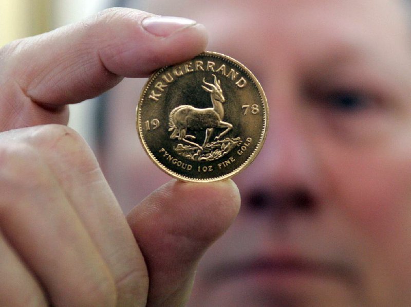A shop owner in Dallas displays a Krugerrand coin in this March 2008 photo. 