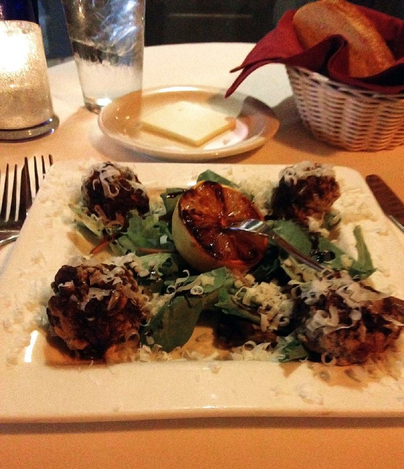 The Grilled Meatballs, an appetizer at Ristorante Capeo, comes with a balsamic vinegar reduction on a bed of dandelion greens. 