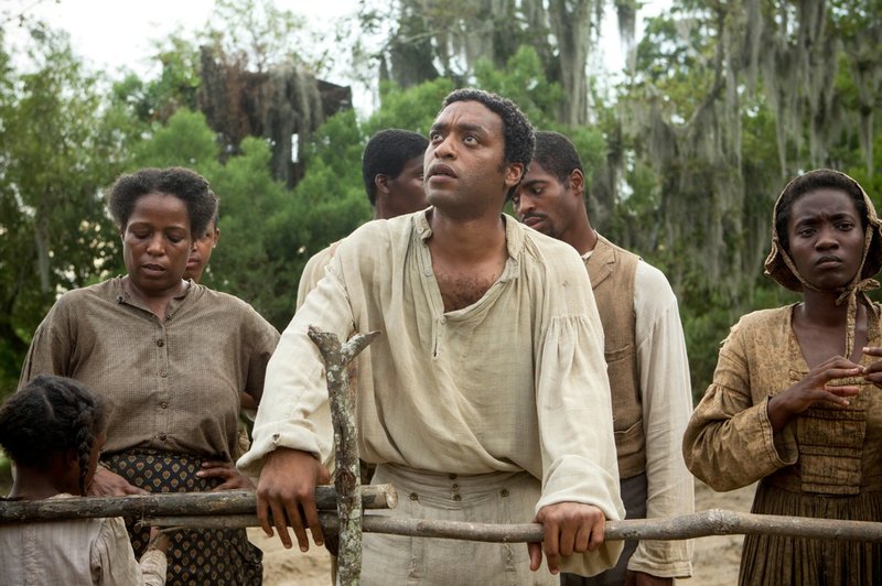 This image released by Fox Searchlight shows Chiwetel Ejiofor, center, in a scene from "12 Years A Slave." Ejiofor was nominated for a Golden Globe for best actor in a motion picture drama for his role in the film on Thursday, Dec. 12, 2013. The 71st annual Golden Globes will air Jan. 12. 