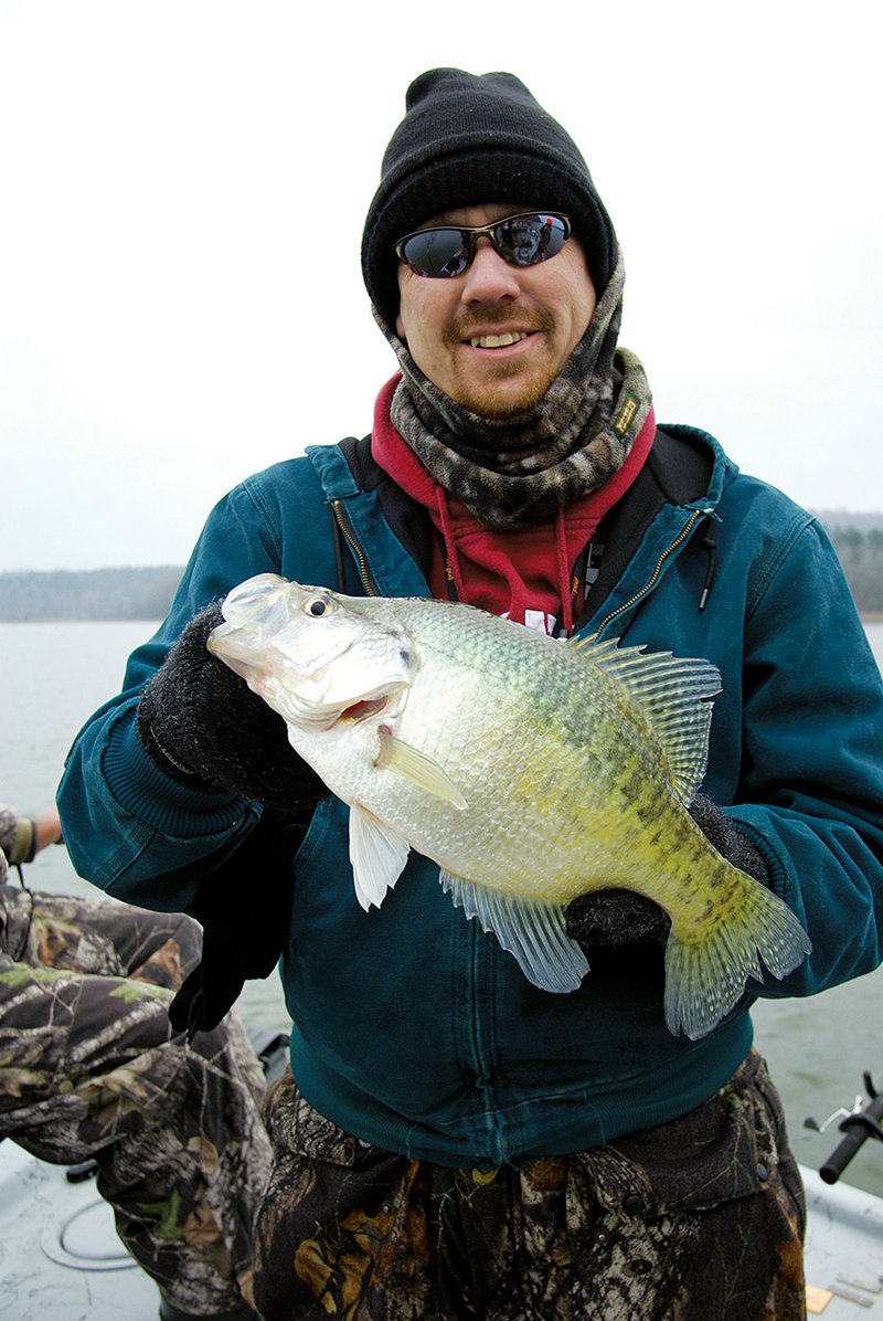 Josh Sutton holds up one of the more than 50 crappie caught on a cold morning while fishing with his father, Keith Sutton, and friend Jerry Blake.