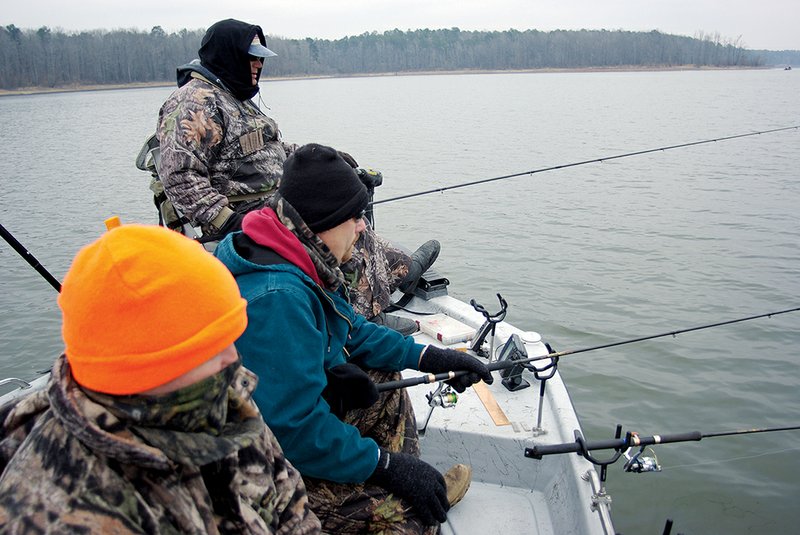 Bundled against the cold, Keith Sutton’s friends watch for crappie to bite on Lake Greeson.