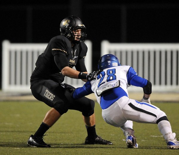 Bentonville tight end Jack Kraus blocks a Conway defender during the fourth quarter of the 7A playoffs game in Bentonville's Tiger Stadium on Friday November 29, 2013.