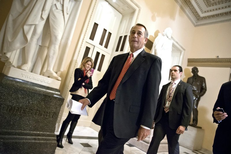 Speaker of the House John Boehner, R-Ohio, walks to the chamber Thursday evening, Dec. 12, 2013, as the House holds final votes before leaving for the holiday recess, at the Capitol in Washington.