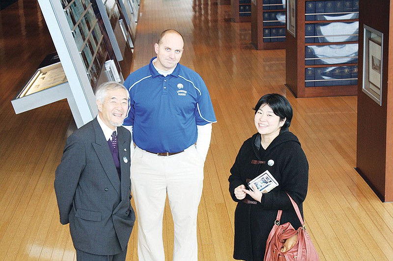 Syoji Omori, left, assistant principal of Hanamaki Higashi; Bruce Orr, assistant superintendent of the Lakeside School District; and Sensu Sato, an English teacher from Hanamaki, leaders of the Sister City exchange program, chat with each other as their students from Lakeside and Hanamaki tour the William J. Clinton Presidential Center in Little Rock on Dec. 5. The Hanamaki group visited Arkansas from Dec. 2-7,