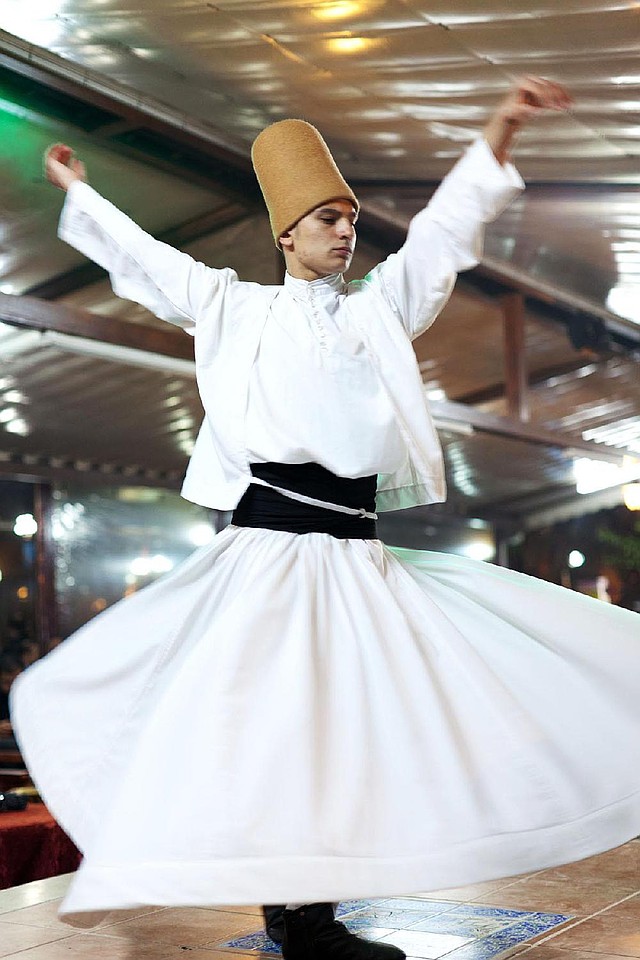 In Turkey, a dervish spins in a prayerful trance, meditating on the divine power of love, the greatness of God and freedom from worldly desires. 