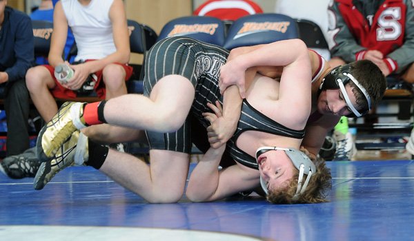 Benny Schaffer, back of Springdale, flips Jeff Bizzle of Bentonville Friday, Dec. 13, 2013, during the NWA Duals tournament at War Eagle Arena in Rogers.