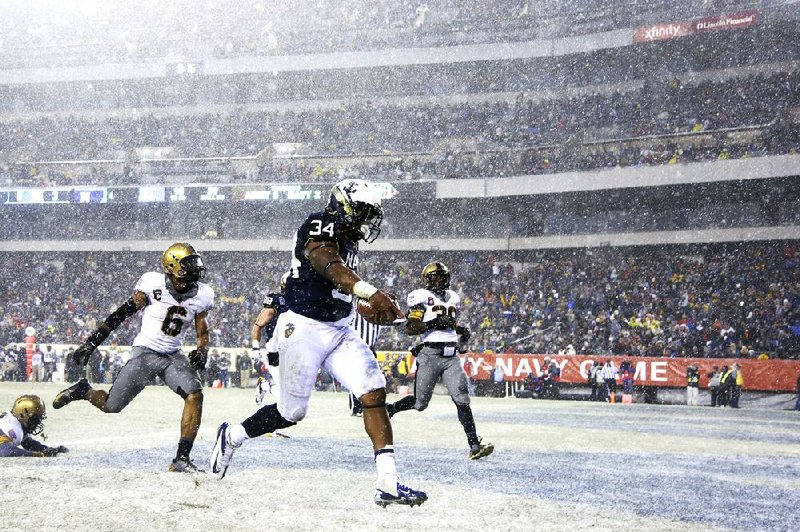 Navy fullback Noah Copeland (34) runs in a touchdown past Army's linebacker Geoffery Bacon (6) and defensive back Josh Jenkins (39) during the first half of an NCAA college football game, Saturday, Dec. 14, 2013, in Philadelphia. (AP Photo/Matt Slocum)