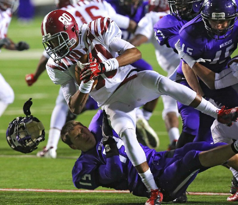 12/14/13
Arkansas Democrat-Gazette/STEPHEN B. THORNTON
El Dorado's Brandon Trostle(19), bottom, looses his helmet as he collides with Pine Bluff's Tyran Simmons (80)  in the first half during their class 6A state football championship game Saturday in Little Rock.
