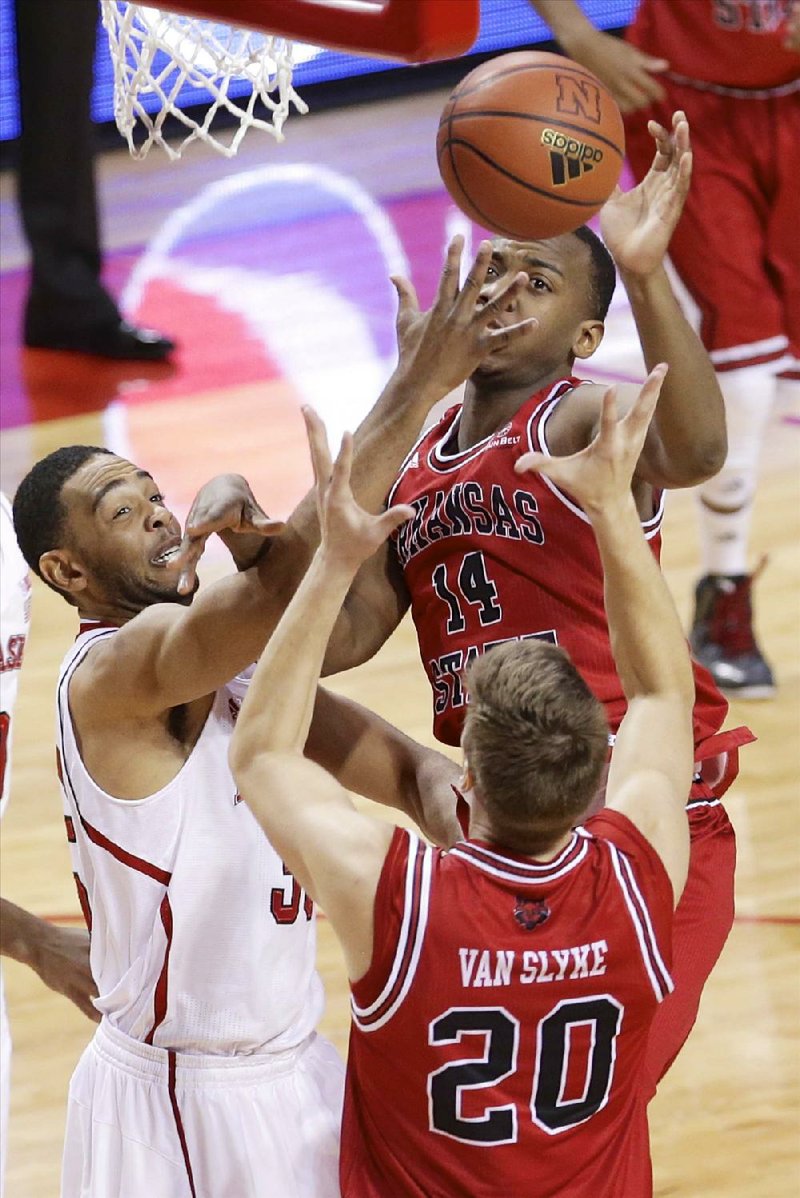 Nebraska's Walter Pitchford, left, competes for a rebound against Arkansas State's Kirk Van Slyke (20) and Kelvin Downs (14) in the first half of an NCAA college basketball game in Lincoln, Neb., Saturday, Dec. 14, 2013. (AP Photo/Nati Harnik)