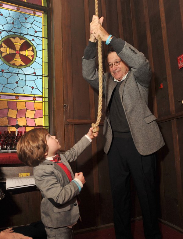 David Lewis, the grandfather of Jesse Lewis, gets a little help from one of his grandsons, Mack Silverman, age 3 from St Loius, as he rings the bells at St. Paul's Episcopal Church in Fayetteville Saturday morning to honor the victims of Sandy Hook Elementary School. Jesse Lewis was one of 20 children and six adults who were shot and killed by a gunman one year ago. Several other churches across the area also rang their bells to honor the victims to the shooting.