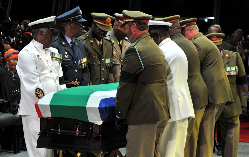 Former South African President Nelson Mandela's casket is taken out of the makeshift tent by military pall bearers following his funeral service in Qunu, South Africa, Sunday, Dec. 15, 2013. (AP Photo/Kopano Tiape, GCIS)