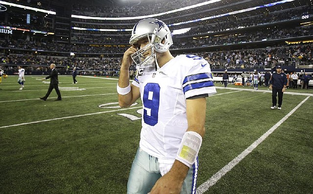 Dallas Cowboys quarterback Tony Romo (9) walks off the field after the 37-36 loss to the Green Bay Packers after an NFL football game Sunday, Dec. 15, 2013, in Arlington, Texas. (AP Photo/Tim Sharp)