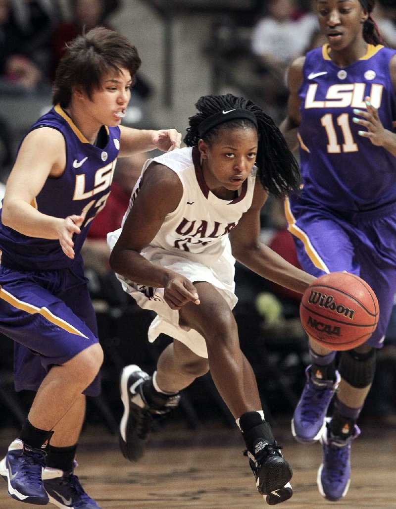 Arkansas Democrat-Gazette/BENJAMIN KRAIN --12/15/2013--
Taylor Gault dribbles past LSU's Rina Hill during the first half of UALR's loss at home Sunday afternoon.