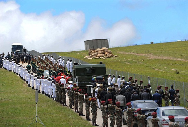 Military personnel line the route as former South African President Nelson Mandela's casket is taken to its burial place in Qunu, South Africa, Sunday, Dec. 15, 2013. (AP Photo/Felix Dlangamandla, Pool)