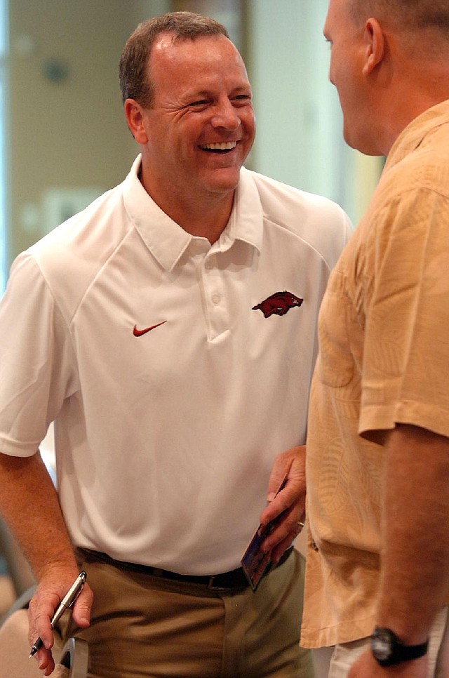 Arkansas Democrat-Gazette/KAREN E. SEGRAVE
7/15/10

Tim Horton, (L) recruiting coordinator and running backs coach for the Arkansas Razorbacks laughs with a friend (sorry no ID)before the start of the Little Rock Razorback club held at Park Hill Baptist Church in North Little Rock on Thursday evening.
