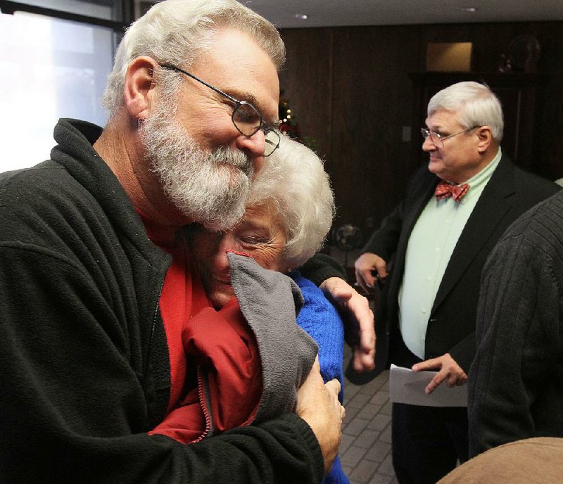 Arkansas Democrat-Gazette/BENJAMIN KRAIN --12/16/2013--
Supporters of proposed Redfield Tri-County Charter School in Redfield, Greg Farley, left, Jane Marsh and Conley Byrd, right, celebrate after the state Board of Education voted to review the Charter Authorizing Panel's decision to deny the school's application.