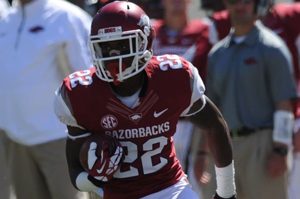 Arkansas running back Nate Holmes (22) carries the ball through the Southern Mississippi defense Saturday, Sept. 14, 2013, during the fourth quarter of play at Razorback Stadium in Fayetteville.