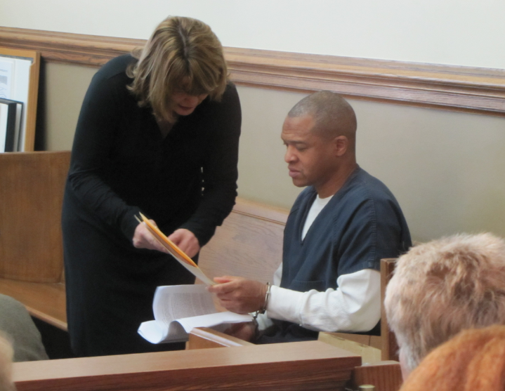 Darrell Dennis looks over case paperwork Tuesday after an appearance in Pulaski County Circuit Court.