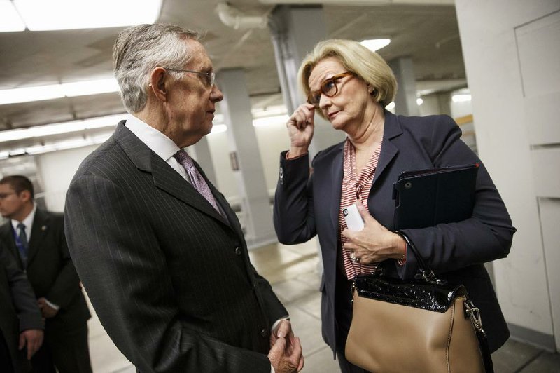 Senate Majority Leader Harry Reid speaks with Sen. Claire McCaskill, D-Mo., outside the Senate after the bipartisan budget compromise cleared a key procedural hurdle with 12 GOP votes. 