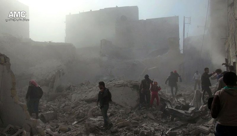 In this Tuesday, Dec. 17, 2013, citizen journalism image provided by Aleppo Media Center, AMC and released Wednesday, Dec. 18, 2013, which has been authenticated based on its contents and other AP reporting, Syrians inspect the rubble of damaged buildings following a Syrian government airstrike in Aleppo, Syria. Syrian warplanes dumped explosive-laden barrel bombs over opposition-held parts of the northern city of Aleppo on Wednesday, the fourth day of a relentless offensive to drive rebels out of the contested city, activists said. 