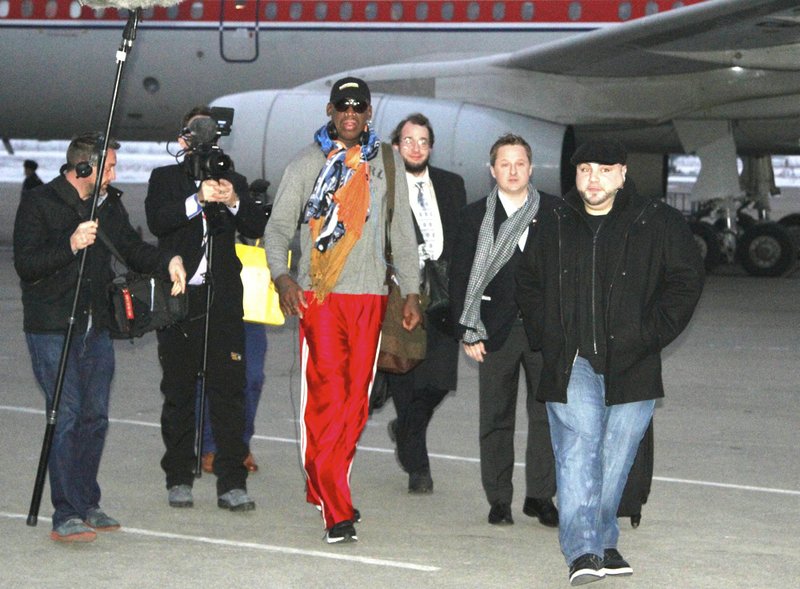 Former NBA basketball star Dennis Rodman disembarks from a North Korean Air Koryo flight from Beijing as he and his entourage arrive at the international airport in Pyongyang, North Korea, on Thursday, Dec. 19, 2013. 