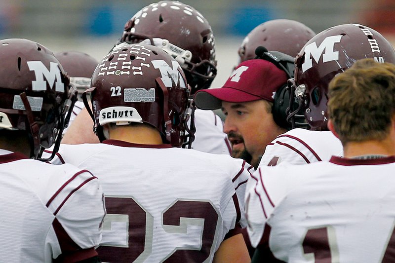 Morrilton head coach Cody McNabb discusses strategy with his team during a timeout.