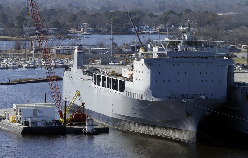 Workers unload equipment from the MV Cape Ray part of the U.S. maritime reserve fleet in Portsmouth, Va., on Thursday, Dec. 19, 2013. The bulk of Syria’s chemical weapons stocks could be destroyed early next year inside the specially modified hold of the ship somewhere at sea. 