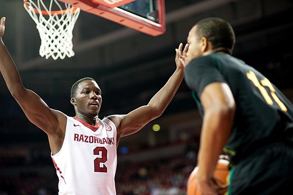 Arkansas' Alandise Harris (2) defends Southeastern Louisiana's Antonnio Benton (11) during the first half of an NCAA college basketball game in Fayetteville, Ark., Tuesday, Dec. 3, 2013. Arkansas won 111-65. (AP Photo/Sarah Bentham)